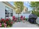 Outdoor patio features a dining table, umbrella, grill, and well-maintained flower beds for outdoor enjoyment at 2110 Cool Springs Ct, Kannapolis, NC 28083