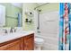 Bathroom with wood vanity, marble countertop, white tub and shower combo, and black shelving at 2110 Cool Springs Ct, Kannapolis, NC 28083