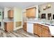 Well-lit kitchen featuring wood cabinets, modern backsplash, and updated countertops with natural light at 2110 Cool Springs Ct, Kannapolis, NC 28083