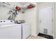 Convenient laundry room with modern appliances, shelving for storage, and an exterior door for easy access at 2110 Cool Springs Ct, Kannapolis, NC 28083