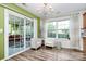 Inviting sunroom with sliding glass doors and an elegant chandelier, perfect for relaxing and entertaining guests at 2110 Cool Springs Ct, Kannapolis, NC 28083