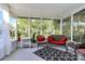 Screened sunroom with lots of seating options, neutral paint, and big glass windows all around at 2110 Cool Springs Ct, Kannapolis, NC 28083