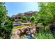 Tranquil backyard featuring a stunning in-ground pool, waterfall and lush greenery at 2153 Darian Way, Waxhaw, NC 28173