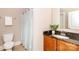 Bright bathroom featuring a vanity with granite countertops, a toilet, and shower with a light blue shower curtain at 2153 Darian Way, Waxhaw, NC 28173