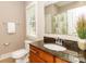 Bathroom with granite vanity, white sink, toilet, a towel bar, and a mirror reflecting a large window and shower at 2153 Darian Way, Waxhaw, NC 28173