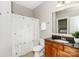Well-lit bathroom with a single vanity, a shower with a curtain, and tile flooring at 2153 Darian Way, Waxhaw, NC 28173