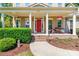 Inviting front porch with classic columns, hanging flower baskets, and a cozy seating area at 2153 Darian Way, Waxhaw, NC 28173