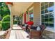 Inviting porch with comfortable seating, perfect for enjoying the outdoors, with bright hanging flowers and a red front door at 2153 Darian Way, Waxhaw, NC 28173