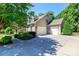 Spacious three-car garage connected to a charming two-story home, surrounded by mature trees and manicured landscaping at 2153 Darian Way, Waxhaw, NC 28173