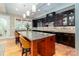 Modern kitchen featuring granite countertops, a kitchen island, and dark cabinetry for a sleek design at 2153 Darian Way, Waxhaw, NC 28173