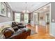 Elegant living room with leather seating, natural light, and hardwood floors creates a welcoming atmosphere at 2153 Darian Way, Waxhaw, NC 28173