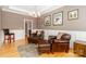 Comfortable living room showcasing leather seating, decorative artwork, and a cozy ambiance at 2153 Darian Way, Waxhaw, NC 28173