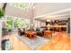 Bright living room with soaring windows, wood floors, and comfortable leather seating, perfect for relaxation at 2153 Darian Way, Waxhaw, NC 28173