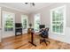Bright home office with hardwood floors, three windows, and ample space for productivity and focus at 2153 Darian Way, Waxhaw, NC 28173