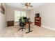 Spacious office with a modern, adjustable desk, ergonomic chair, and built-in bookcase, illuminated by a large window at 2153 Darian Way, Waxhaw, NC 28173