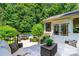 Outdoor patio with seating area overlooking a fenced pool and outdoor dining space, surrounded by lush greenery at 2153 Darian Way, Waxhaw, NC 28173