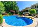 Gorgeous in-ground pool with a built-in fire pit and outdoor seating area at 2153 Darian Way, Waxhaw, NC 28173