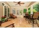 Charming screened porch with travertine tile flooring, cozy seating area, and dining set for outdoor enjoyment at 2153 Darian Way, Waxhaw, NC 28173