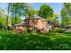 Lush green backyard showcasing the home's brick exterior and a patio area at 242 Beckham Ct, Charlotte, NC 28211