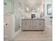 Bright bathroom featuring a double vanity, a glass shower and patterned rug at 242 Beckham Ct, Charlotte, NC 28211