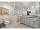 Bright bathroom featuring a double vanity, a glass shower and toilet at 242 Beckham Ct, Charlotte, NC 28211