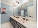 Well-lit bathroom featuring double sinks, a large mirror, and stylish fixtures for a spa-like experience at 242 Beckham Ct, Charlotte, NC 28211