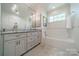 Bright bathroom featuring a double vanity and tub with white tiling at 242 Beckham Ct, Charlotte, NC 28211