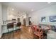 Bright breakfast area featuring a banquette, kitchen bar, and a pass-through to the kitchen at 242 Beckham Ct, Charlotte, NC 28211