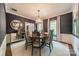 Elegant dining room with sophisticated wallpaper, chandelier, and seating for six, perfect for memorable gatherings at 242 Beckham Ct, Charlotte, NC 28211