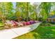 Long driveway lined with azaleas leading to a charming home surrounded by lush greenery at 242 Beckham Ct, Charlotte, NC 28211