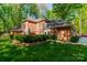 A view of the brick exterior of the home with manicured landscaping at 242 Beckham Ct, Charlotte, NC 28211