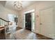Inviting foyer with hardwood floors, elegant chandelier, and a glimpse of the living spaces, promising a warm welcome at 242 Beckham Ct, Charlotte, NC 28211