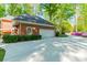 Garage with an extra wide driveway, surrounded by green space at 242 Beckham Ct, Charlotte, NC 28211