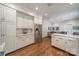 Bright kitchen featuring white cabinets, stainless steel appliances, and hardwood floors at 242 Beckham Ct, Charlotte, NC 28211