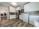 Efficient laundry room with tile floors, cabinets, stainless steel refrigerator, washer, and dryer at 242 Beckham Ct, Charlotte, NC 28211