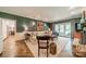 Inviting living room with a fireplace, textured walls, and doors that lead to the backyard at 242 Beckham Ct, Charlotte, NC 28211