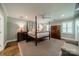 Spacious main bedroom features a four poster bed, hardwood flooring, and shuttered windows at 242 Beckham Ct, Charlotte, NC 28211