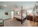 Airy main bedroom with four poster bed, wood flooring, and ensuite access for ultimate comfort at 242 Beckham Ct, Charlotte, NC 28211