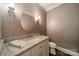 Stylish powder room features patterned wallpaper, modern vanity, and elegant lighting at 242 Beckham Ct, Charlotte, NC 28211