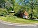 Brick two-story home with attached garage and a well-manicured lawn and garden at 3100 Ventosa Dr, Charlotte, NC 28205
