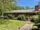 Charming single-story brick home with a well-maintained front yard and lush landscaping at 3100 Ventosa Dr, Charlotte, NC 28205