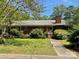 Charming single-story brick home with a well-maintained front yard and lush landscaping at 3100 Ventosa Dr, Charlotte, NC 28205
