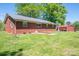 View of brick house and metal detached garage in backyard with an AC unit at 3340 Wrenwood Dr, Newton, NC 28658