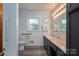 A well-lit bathroom with a vanity, mirror, and accessible toilet for convenience and comfort at 3340 Wrenwood Dr, Newton, NC 28658