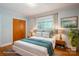 Bright bedroom featuring a comfortable bed, warm hardwood floors, and natural light from the window at 3340 Wrenwood Dr, Newton, NC 28658