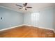 This is a bedroom with a ceiling fan, wood floors, and curtains at 3340 Wrenwood Dr, Newton, NC 28658