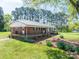 Brick home with a metal roof, porch, and flower beds at 3340 Wrenwood Dr, Newton, NC 28658