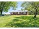 Lovely brick home featuring a large front lawn and mature trees for shade at 3340 Wrenwood Dr, Newton, NC 28658