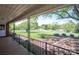 Inviting front porch with iron railings overlooks the lush front yard and serene neighborhood street at 3340 Wrenwood Dr, Newton, NC 28658