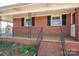 Cozy brick home with a covered front porch, wrought iron railings, and well-maintained landscaping at 3340 Wrenwood Dr, Newton, NC 28658